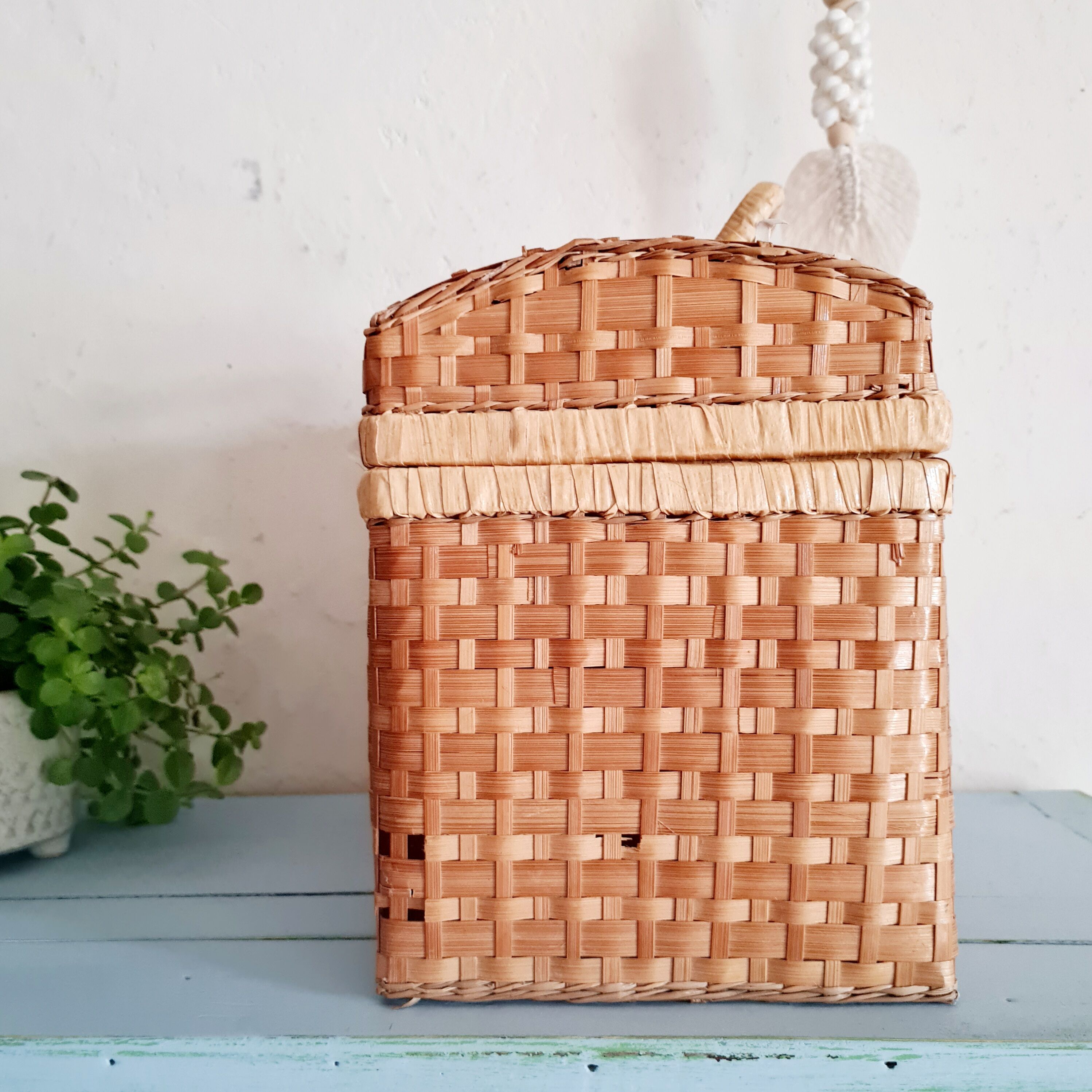 Small suitcase in vintage rattan trunk