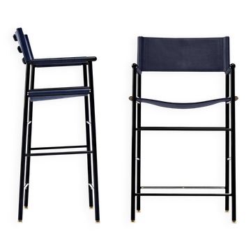 Pair of bar stools with navy blue backrest and metal frame.
