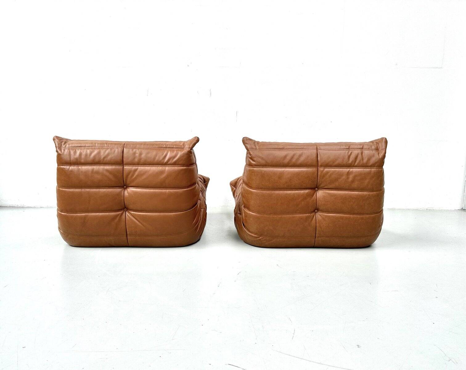 Togo lounge chairs in cognac cow leather attributed to Michel Ducaroy for Ligne Roset, set of 2
