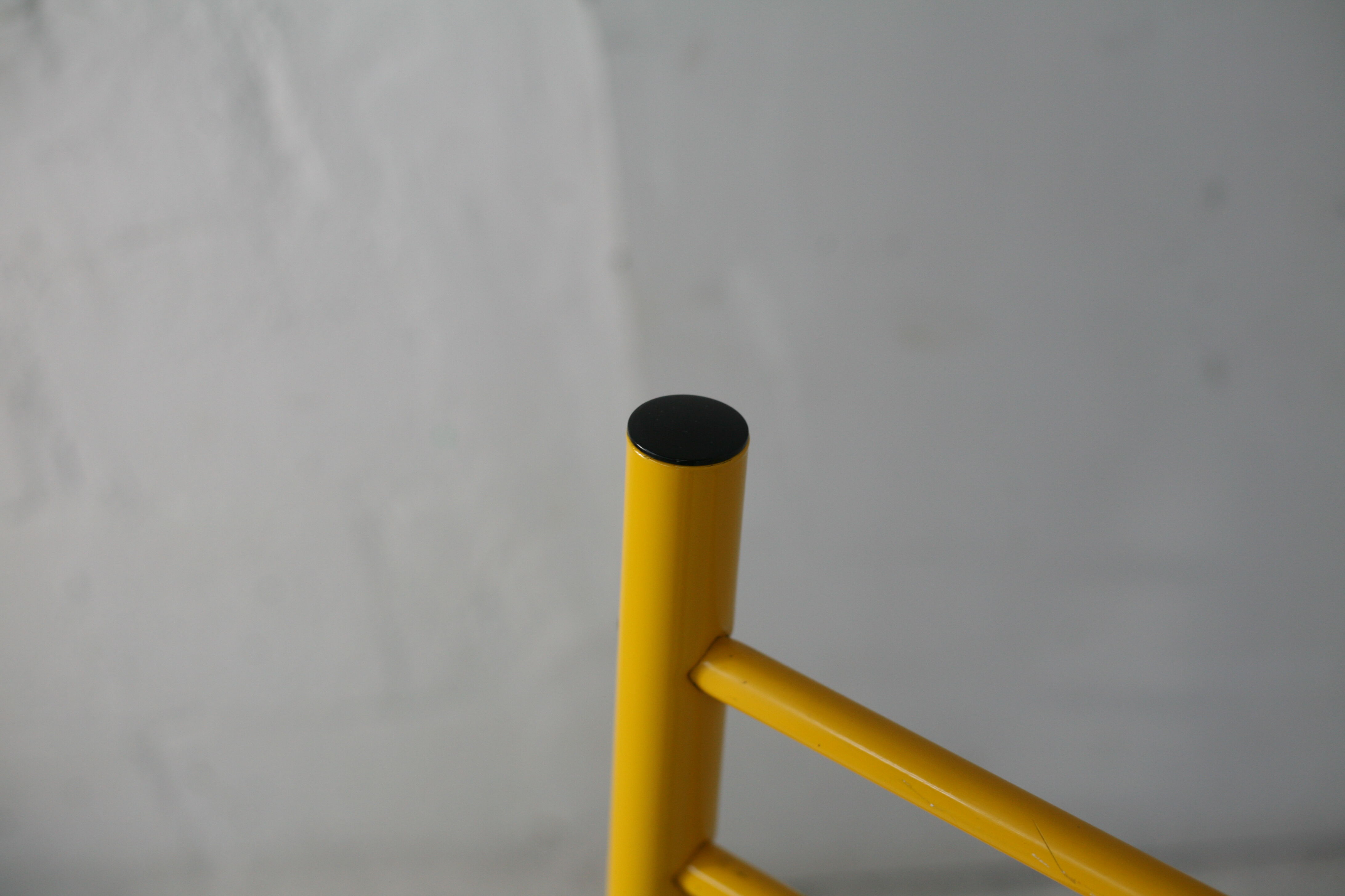 Adjustable seat chair. Circa 1980. Italy. Yellow lacquered steel.