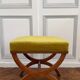 Tabouret curule ancien — noyer, tissu chartreuse, clous laiton