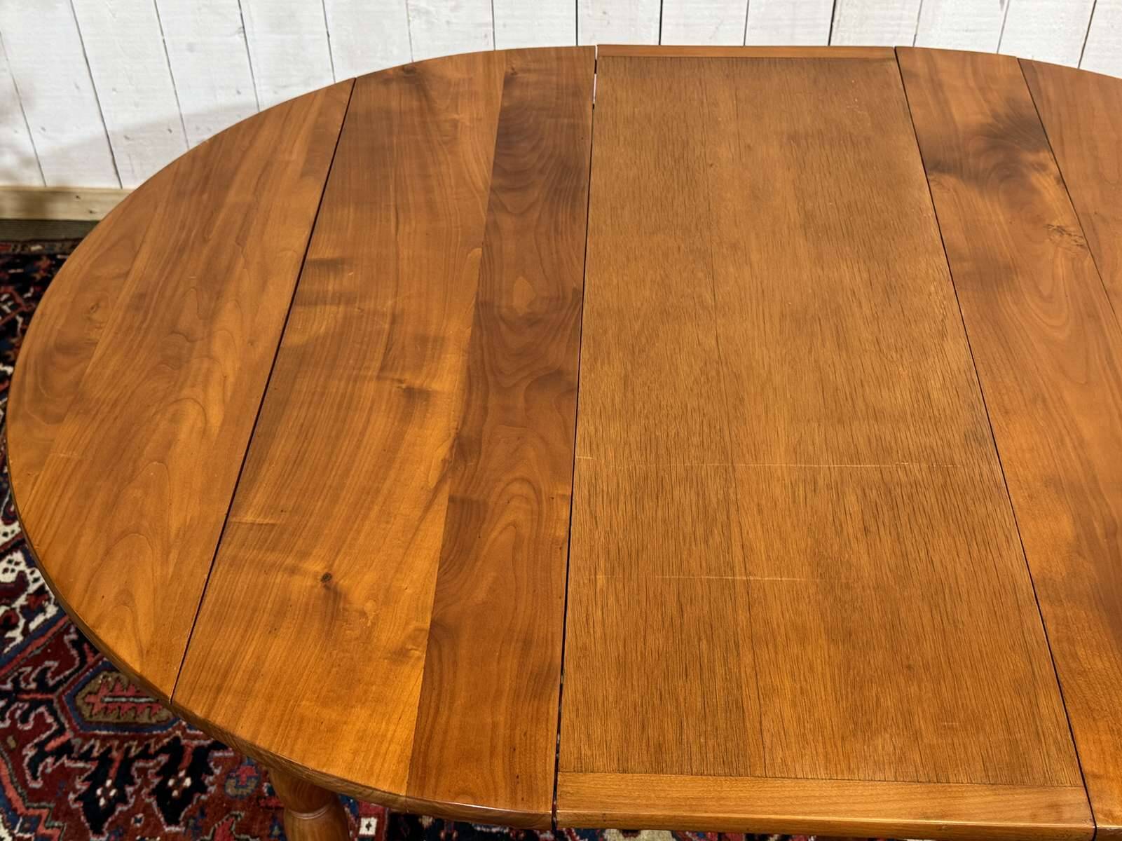 Round cherry wood table, 6 feet, Louis Philippe style with 2 extensions.