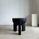 Black mango wood tripod side table with a semi-spherical top, height: 45 cm, diameter: 44 cm.