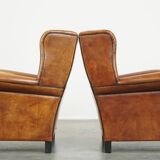 Set of 2 very comfortable large sheepskin armchairs elegantly finished with black piping