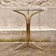 Golden pedestal table in smoked glass
