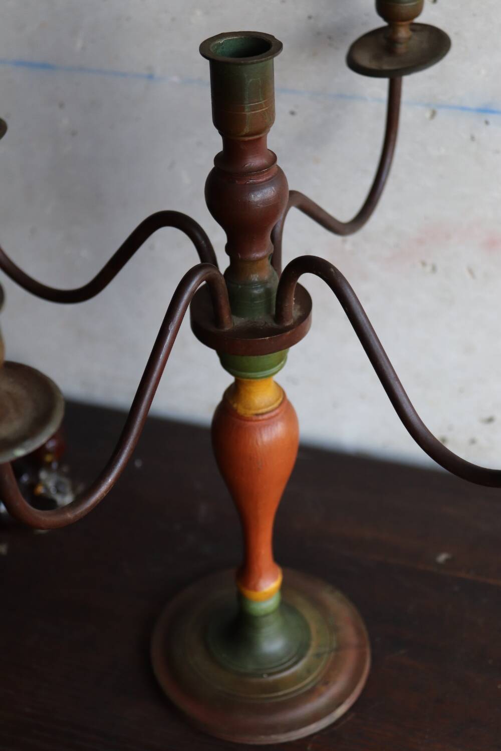 Old candlestick in painted wood and folding metal