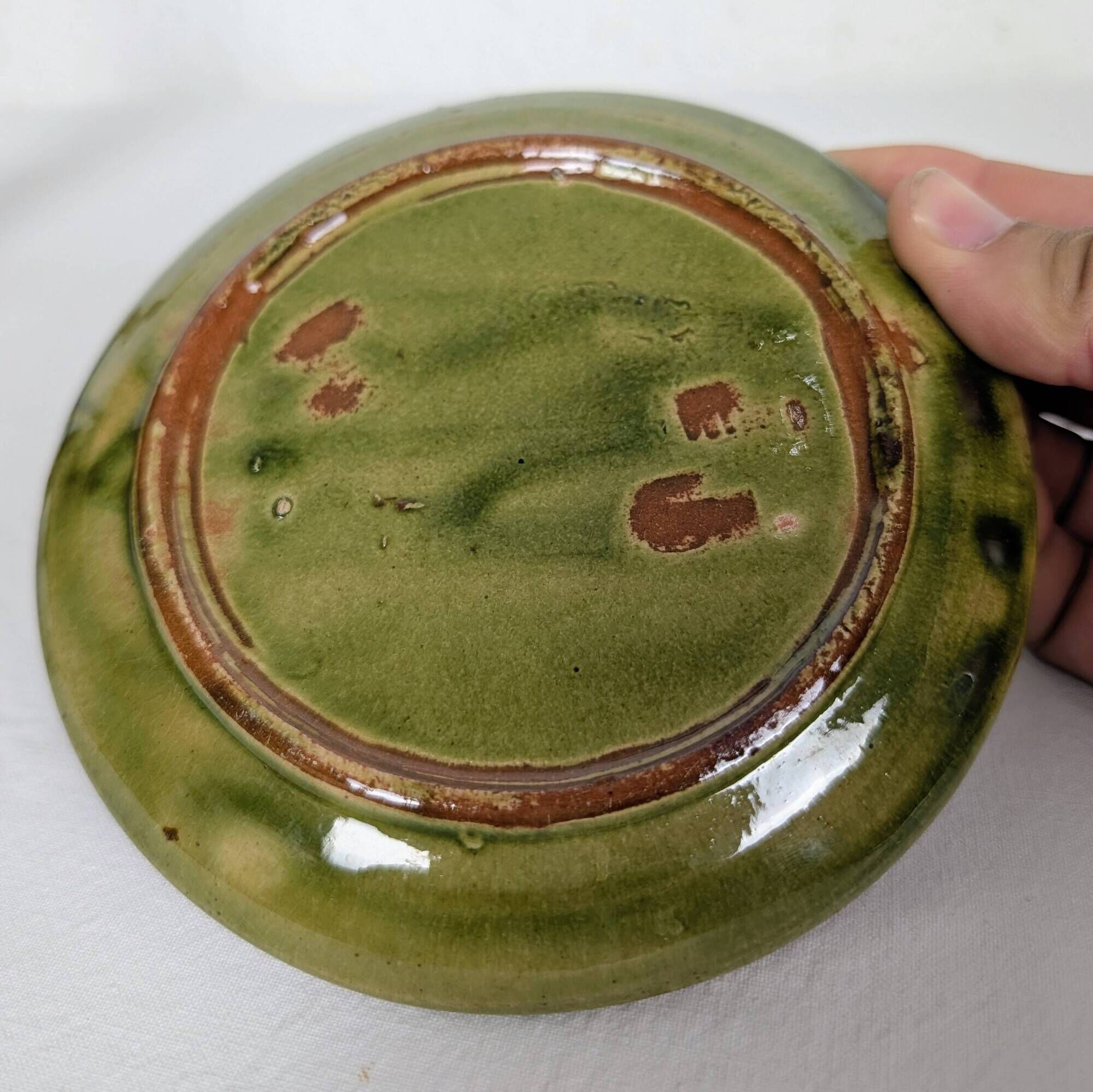 Small plate in glazed green earthenware
