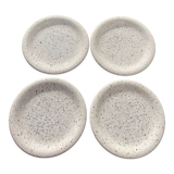 4 black speckled dessert plates on a vintage white background