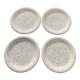 4 black speckled dessert plates on a vintage white background