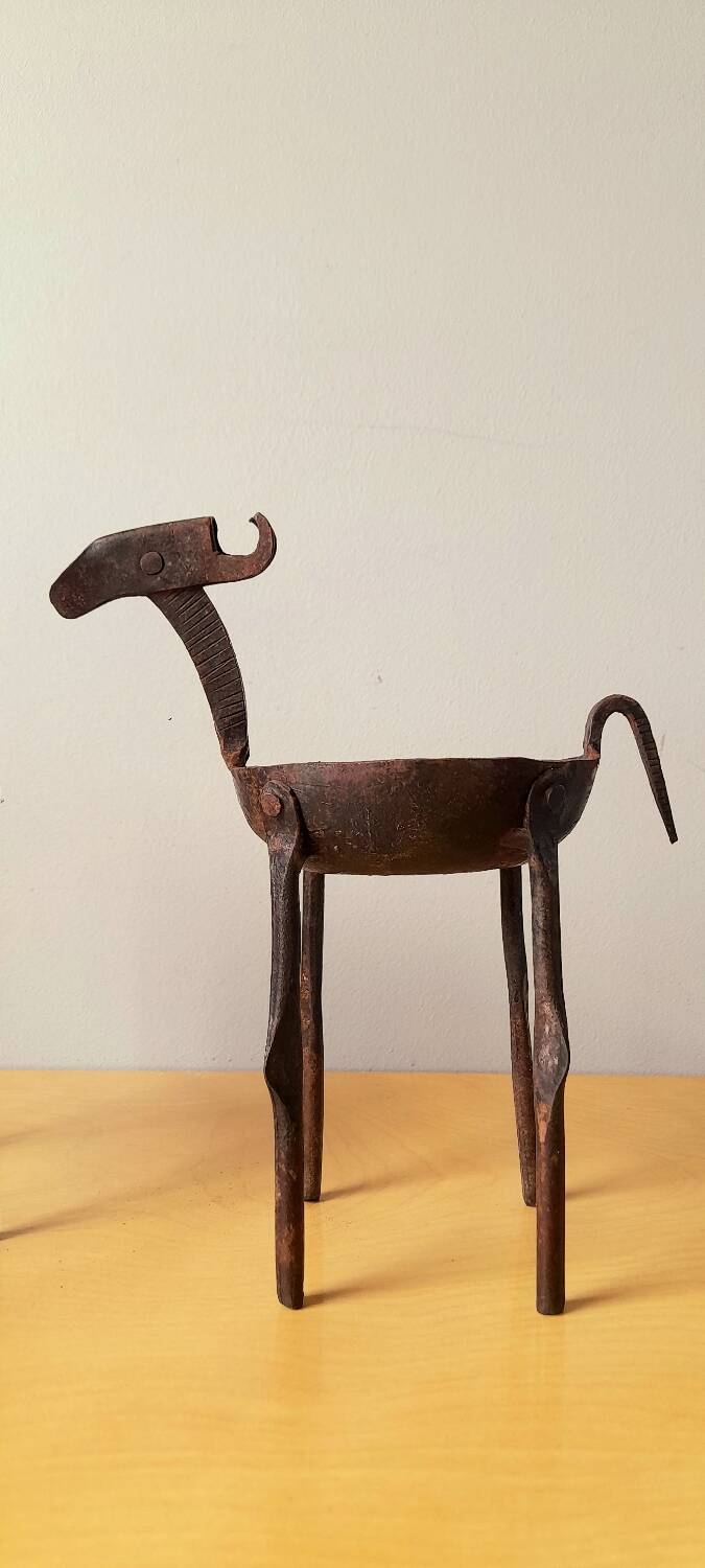 Zoomorphic wrought iron pocket emptier