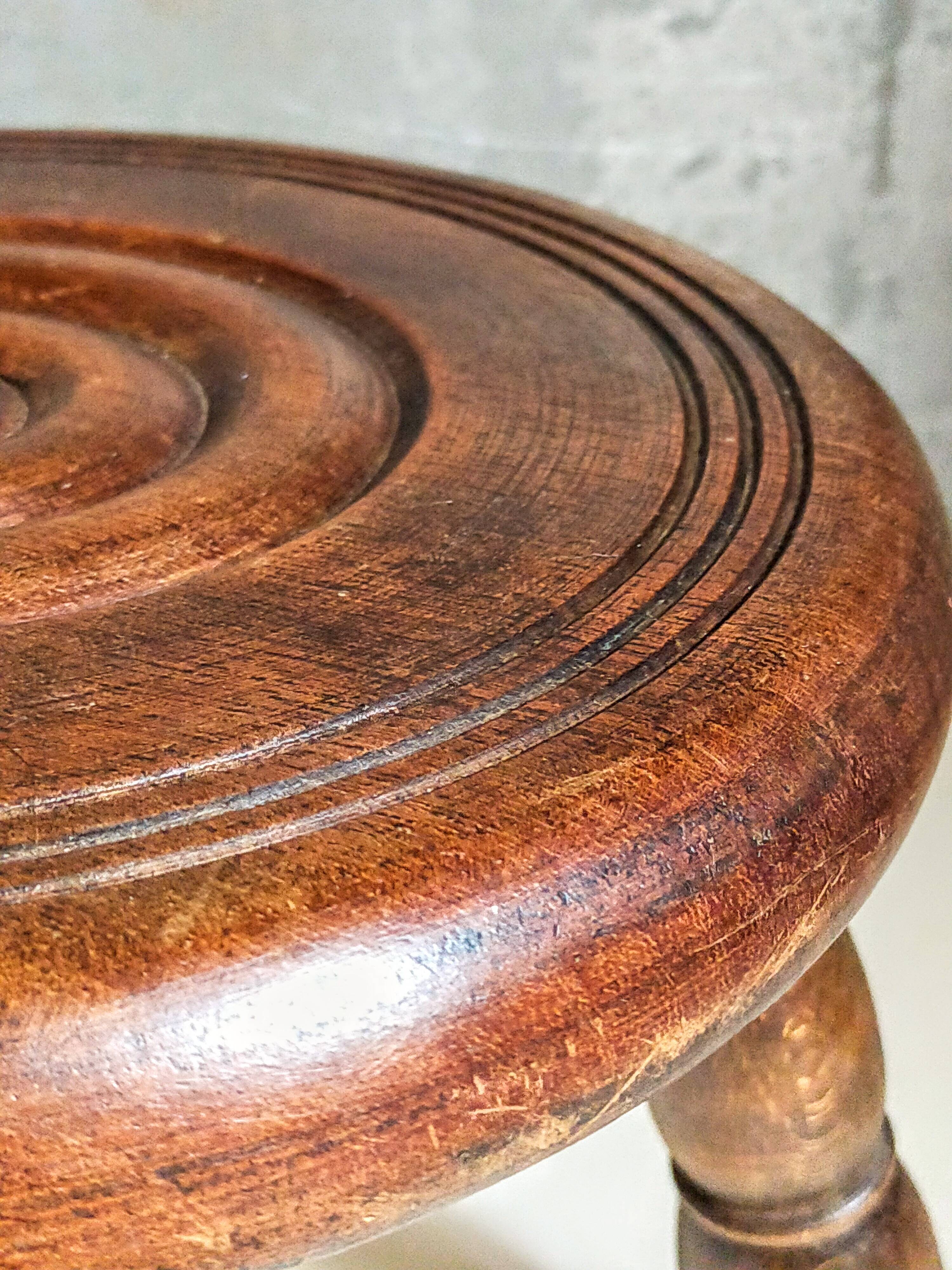 Low tripod stool in vintage turned solid wood