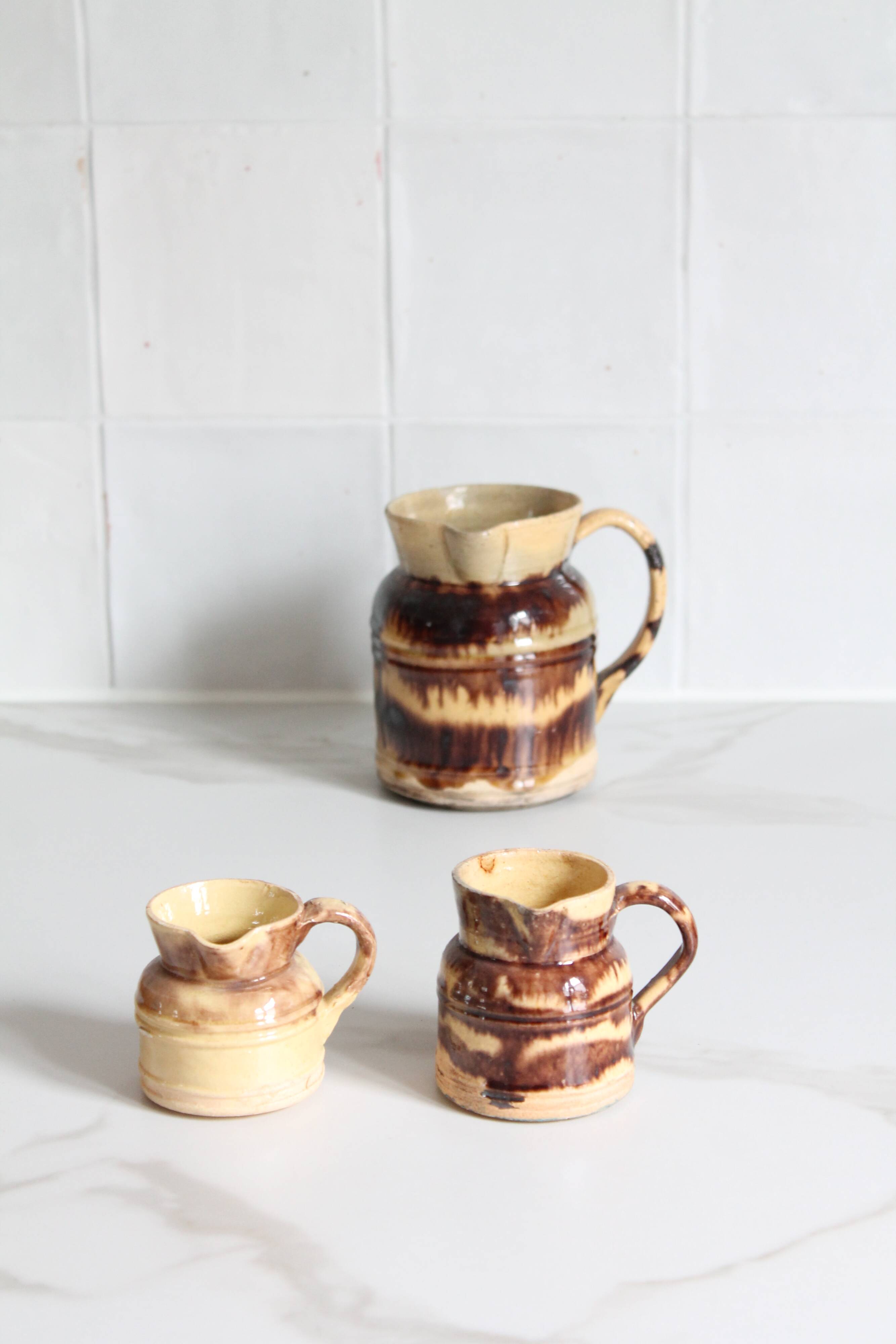 3 old bicoloured enamelled stoneware jugs