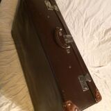 Suitcase vintage leather inside and brown carpeted home