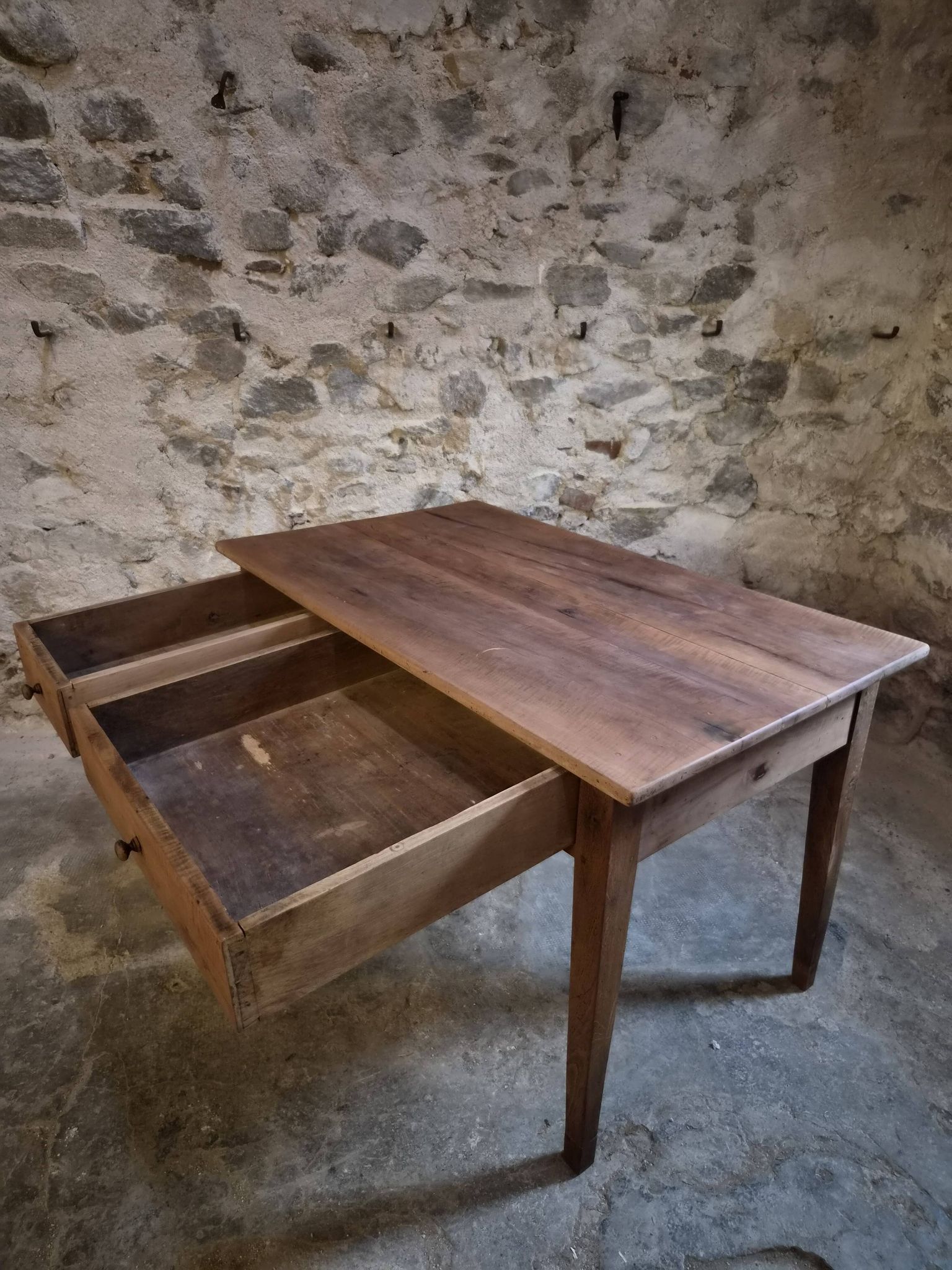 French antique dining table in cherry wood with two drawers, circa 1880–1920.