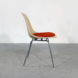 DSX chair with red cushion by Charles and Ray Eames edited by Herman Miller, 1960