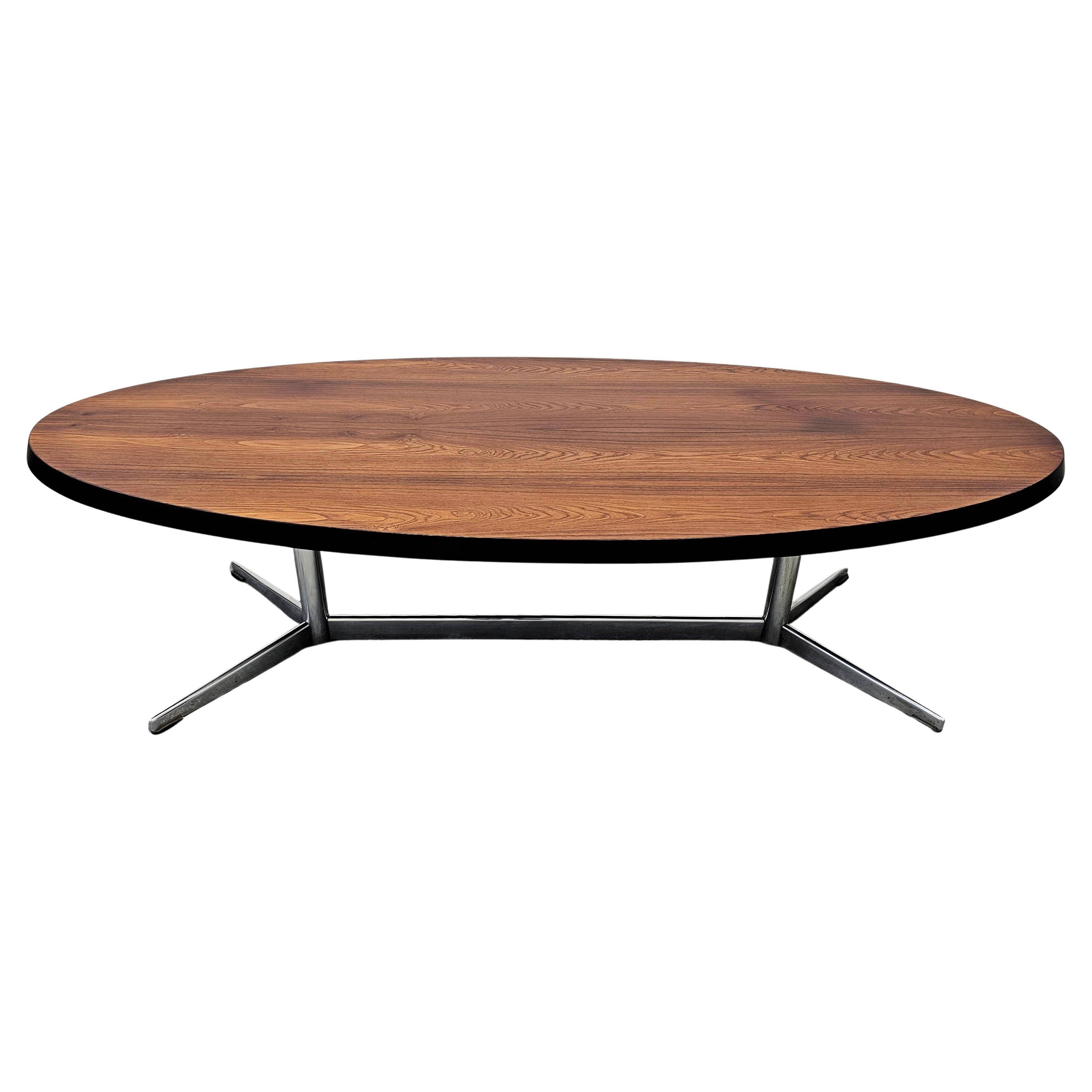 Danish Mid Century Modern oval coffee table with a teak top and chrome legs.