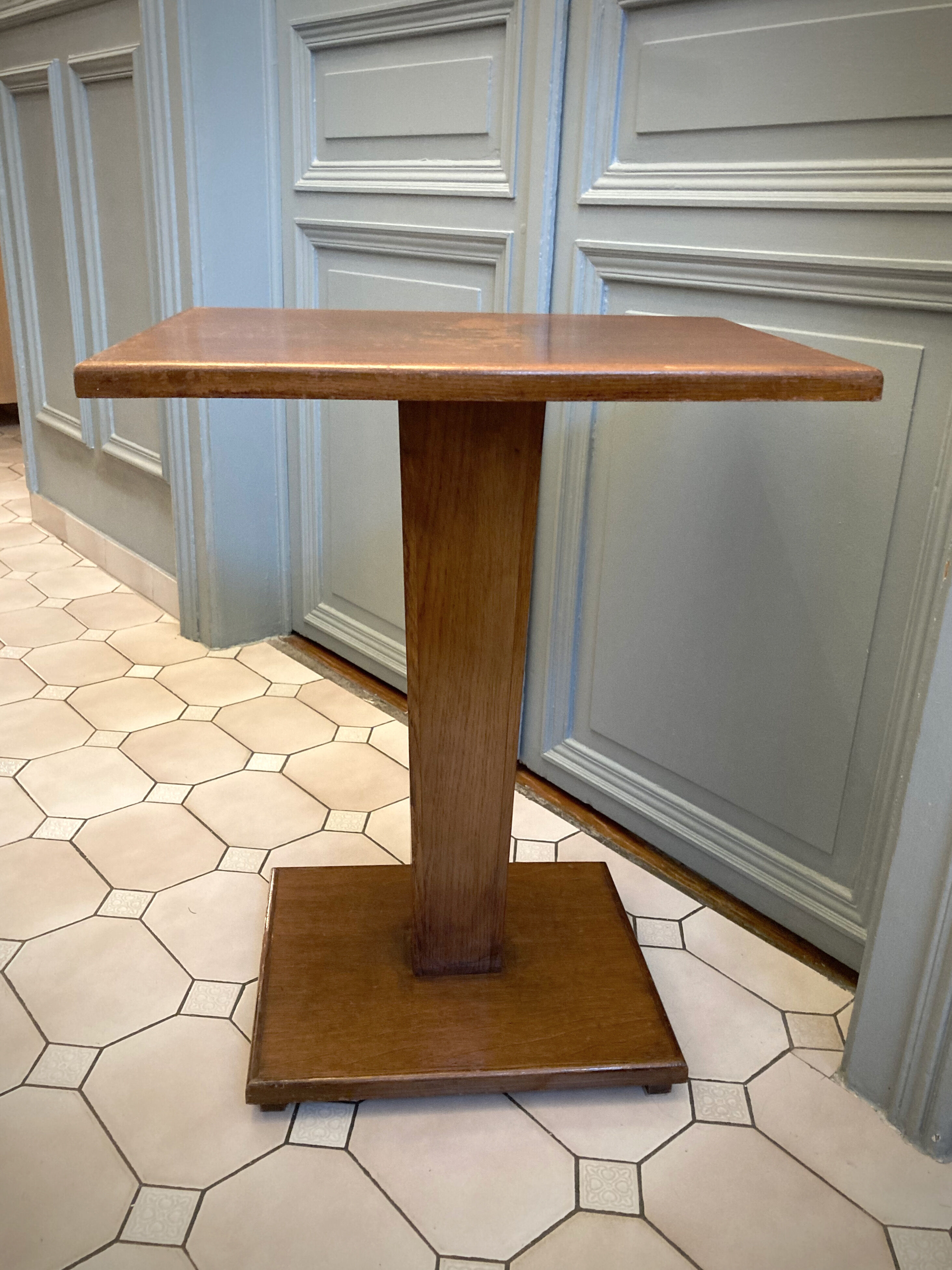 Square pedestal table with central foot 1930