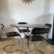 Set consisting of a table in chrome and smoked glass and its 4 tubular chairs in chrome and skaï a