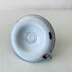 Old candle holder in white enameled metal