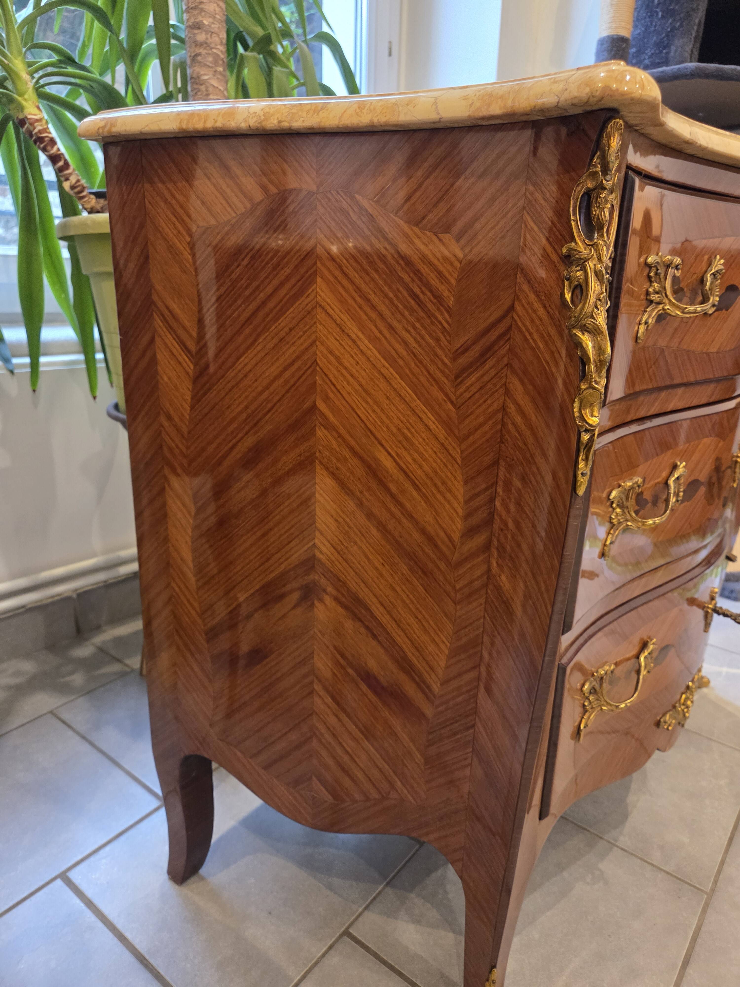 Louis XV style commode with marquetry and marble.