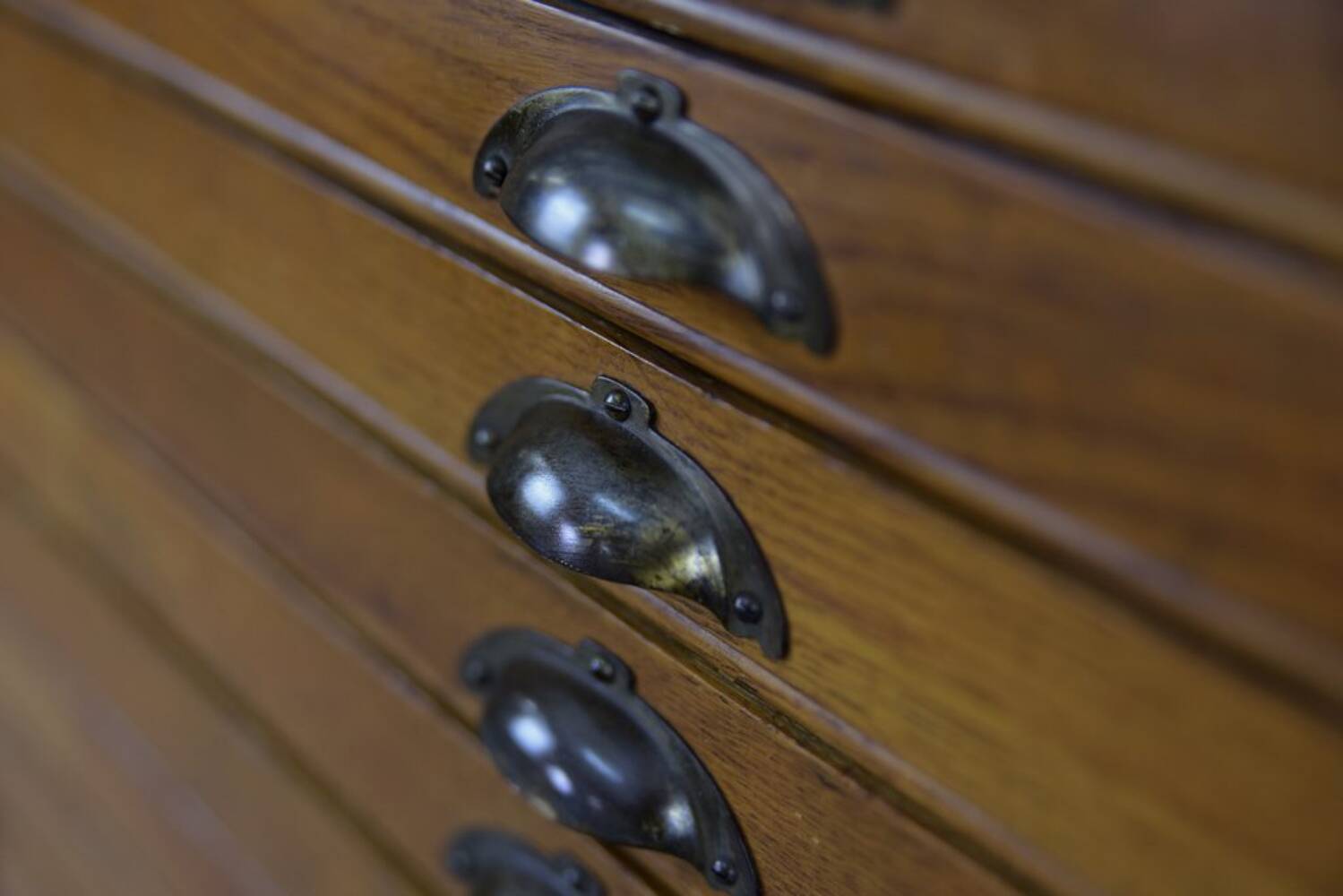 Vintage industrial oak filing cabinet with several drawers, 1930s.