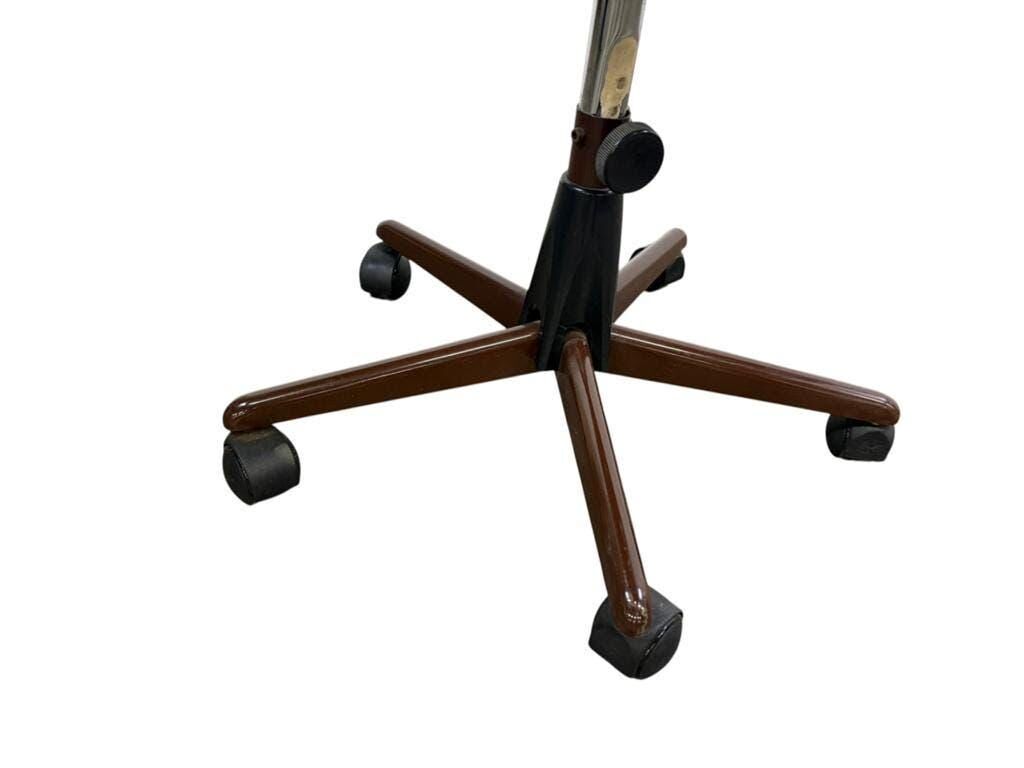 Brown vintage office chair from the 70s on wheels.