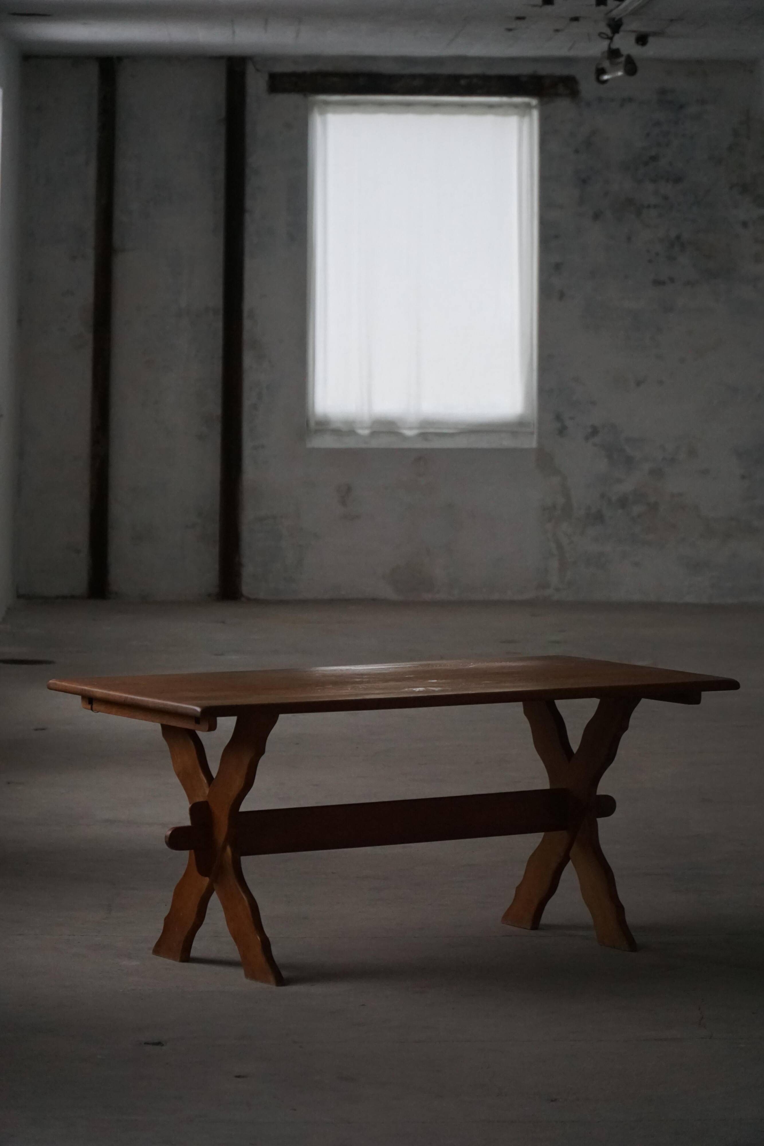 Solid oak dining table with cross base by Danish cabinetmaker, mid-20th century.