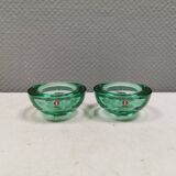 A set of iitalla candle holders in green transparent glass.