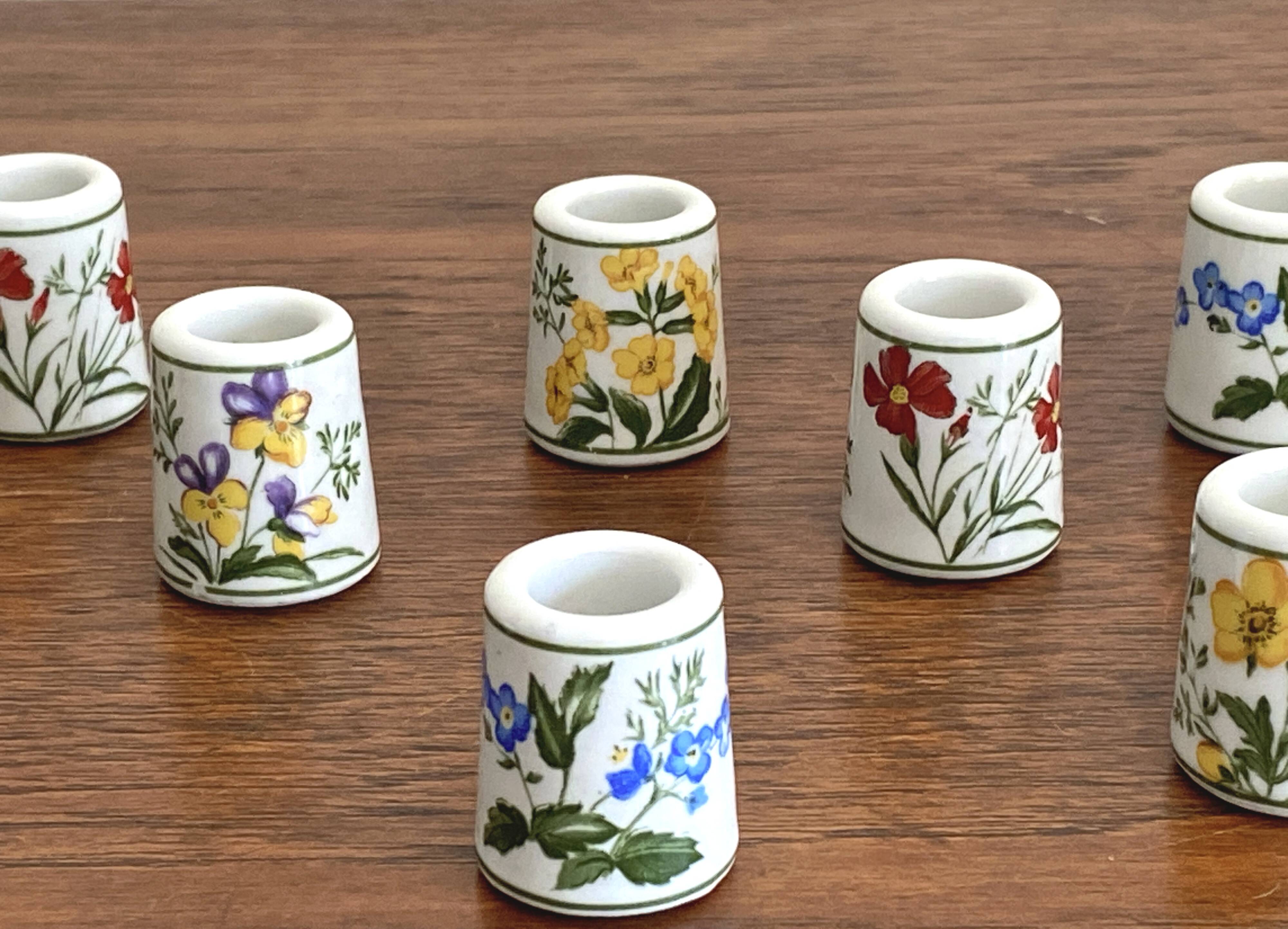 Set of 9 mini vintage porcelain candle holders decorated with spring flowers.