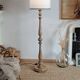 Vintage floor lamp in turned wood with an aged effect.