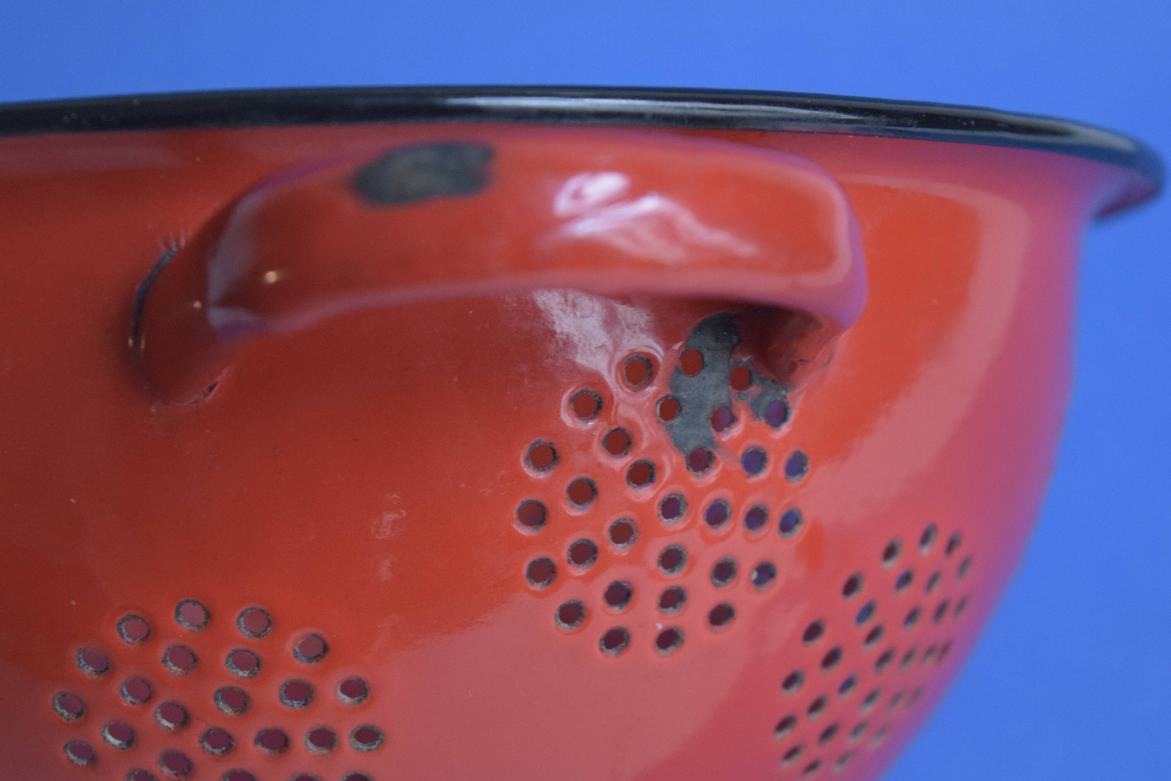 Vintage red enameled sheet metal colander