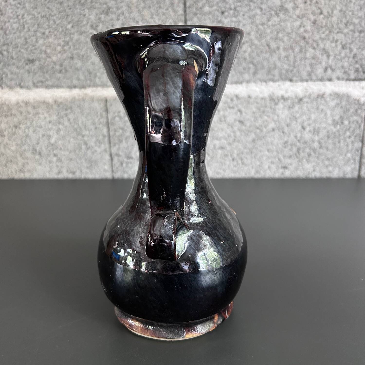 Black vase with yellow flowers