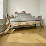 A soft light blue and silver tufted beech wood sofa in Louis style.