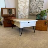 Coffee table with pin legs and gold leaf