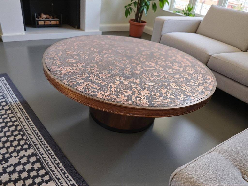 Vintage round wooden coffee table with a copper top.