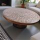 Vintage round wooden coffee table with a copper top.