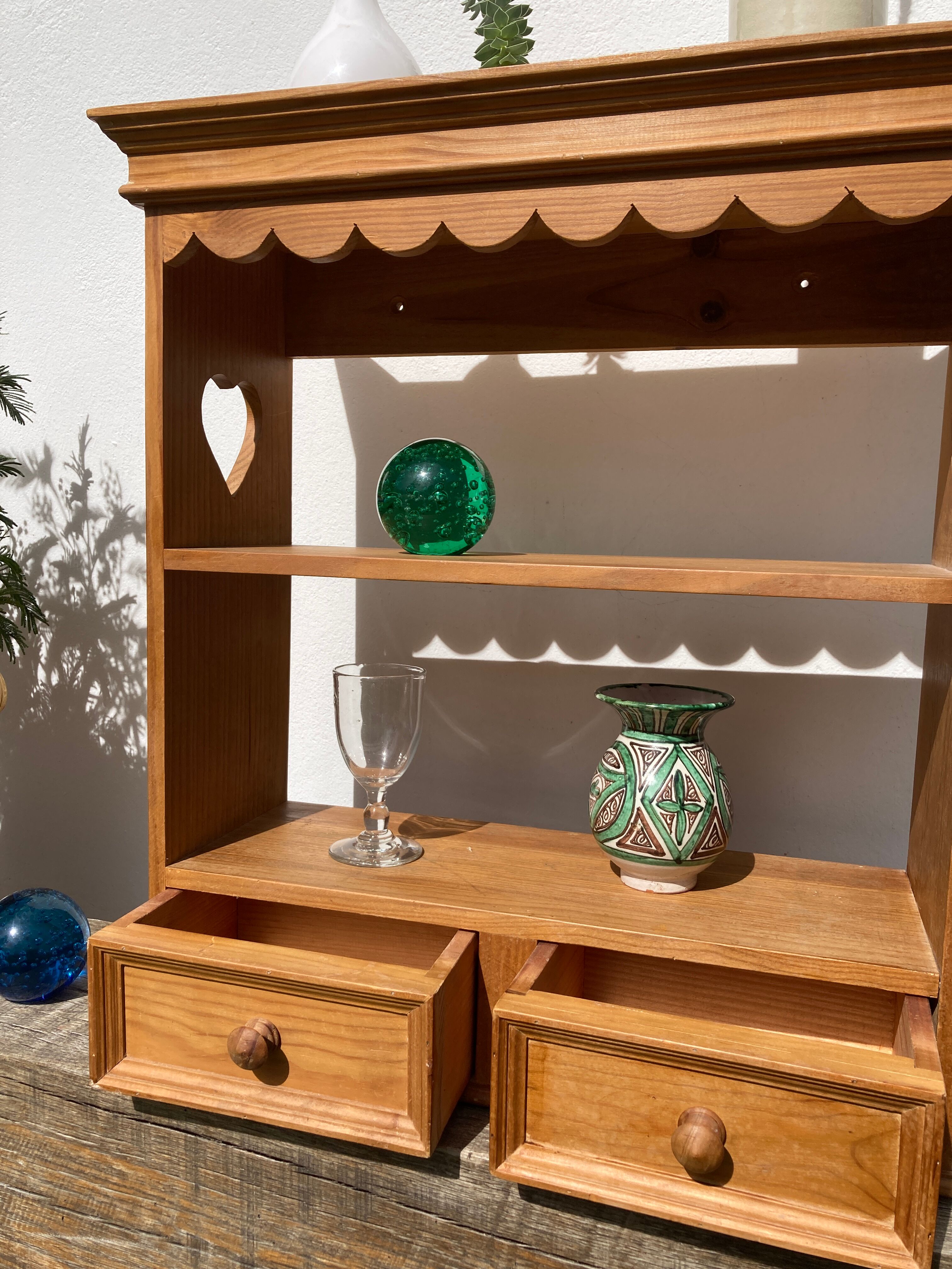 Wall shelf in raw wood with drawers and openwork hearts