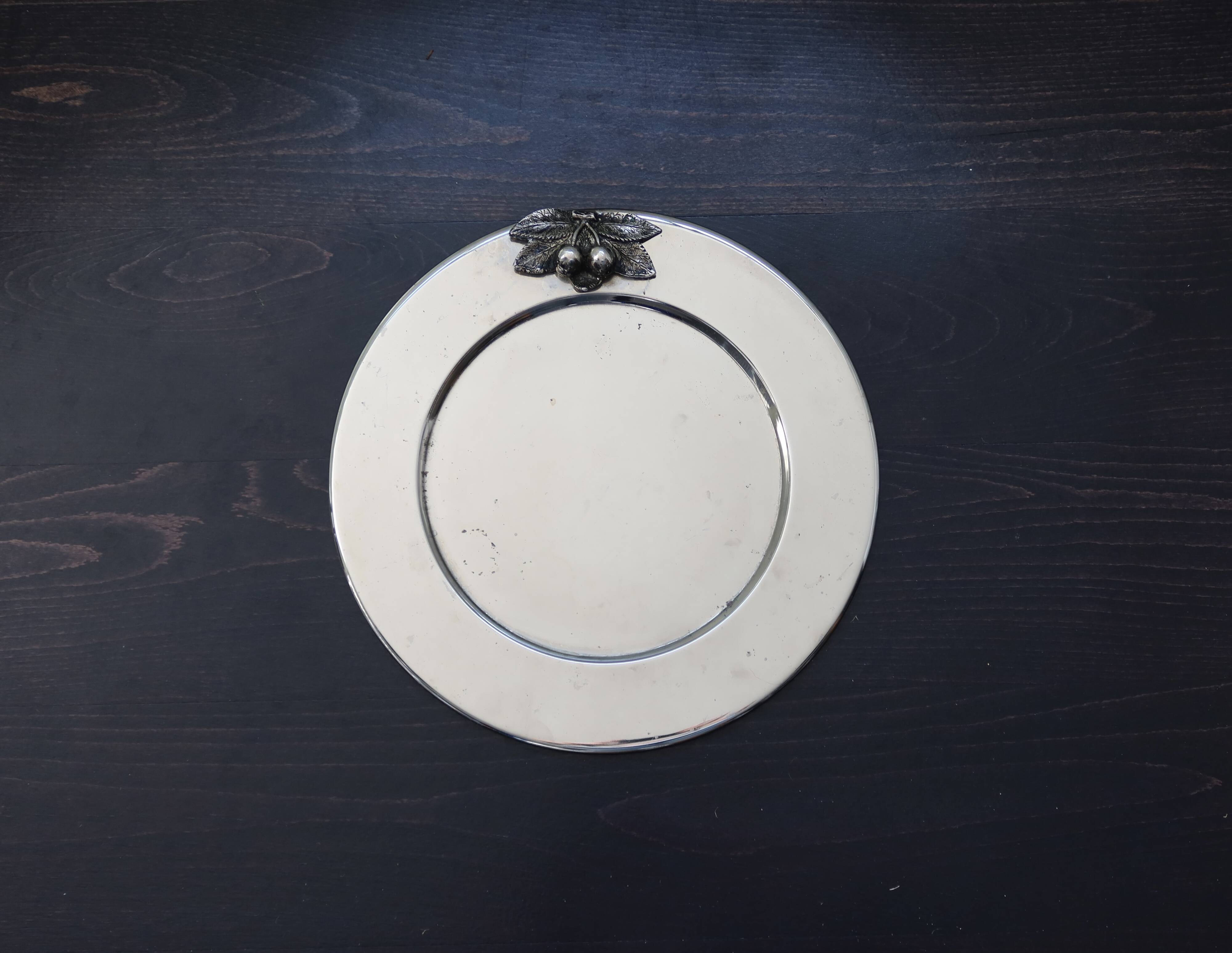 Vintage silver-plated round service tray with embossed cherries.
