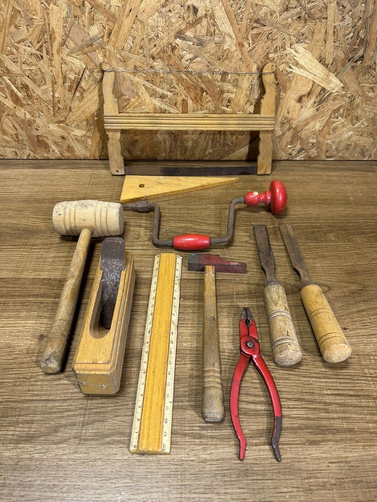lot of antique toys, carpentry tools, wood, saw, plane, hammer,...