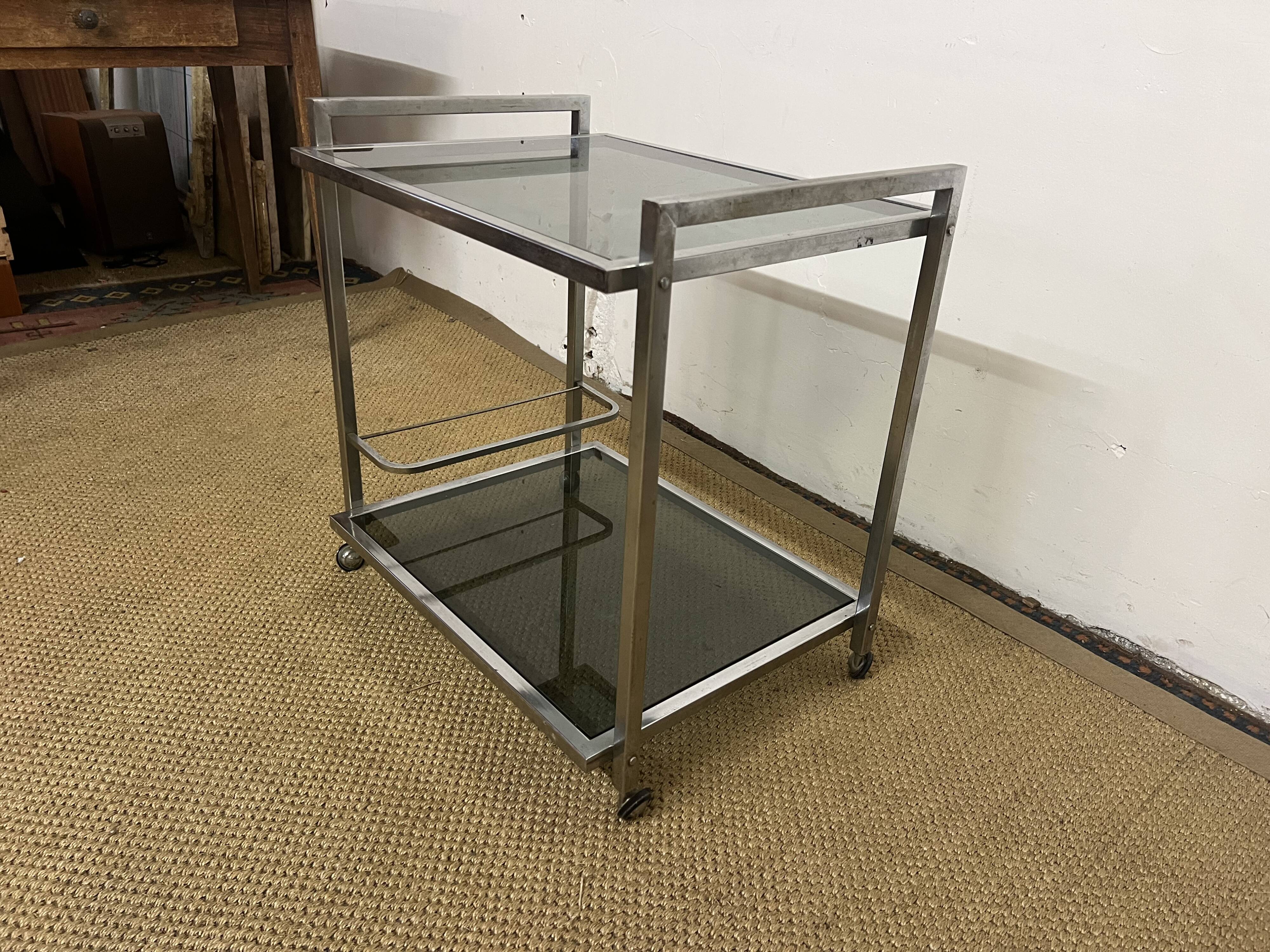 1970s coffee table in brass with a double smoked glass top.
