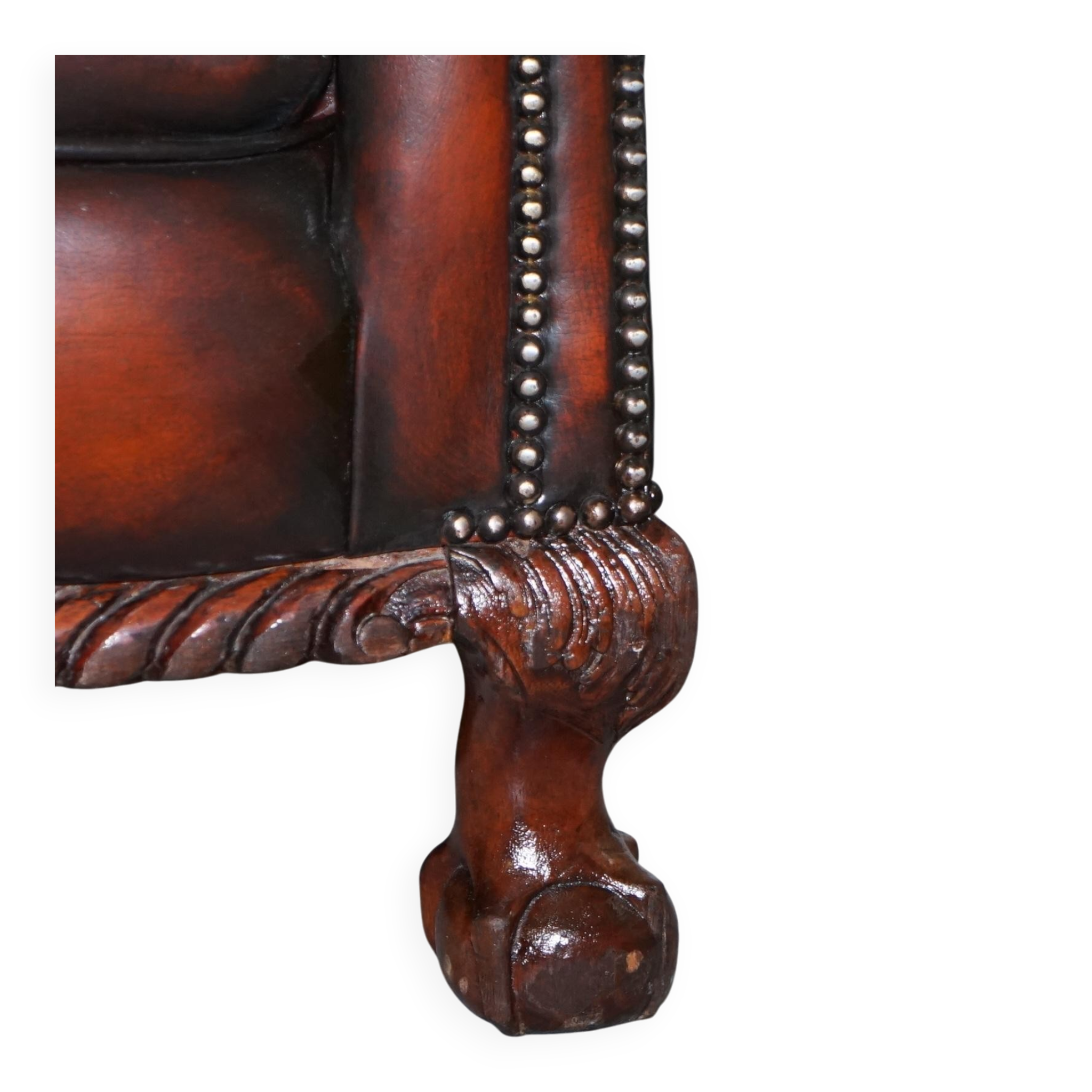 Restored Victorian sofa in leather with claw feet and feather cushions.