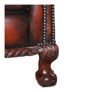 Restored Victorian sofa in leather with claw feet and feather cushions.