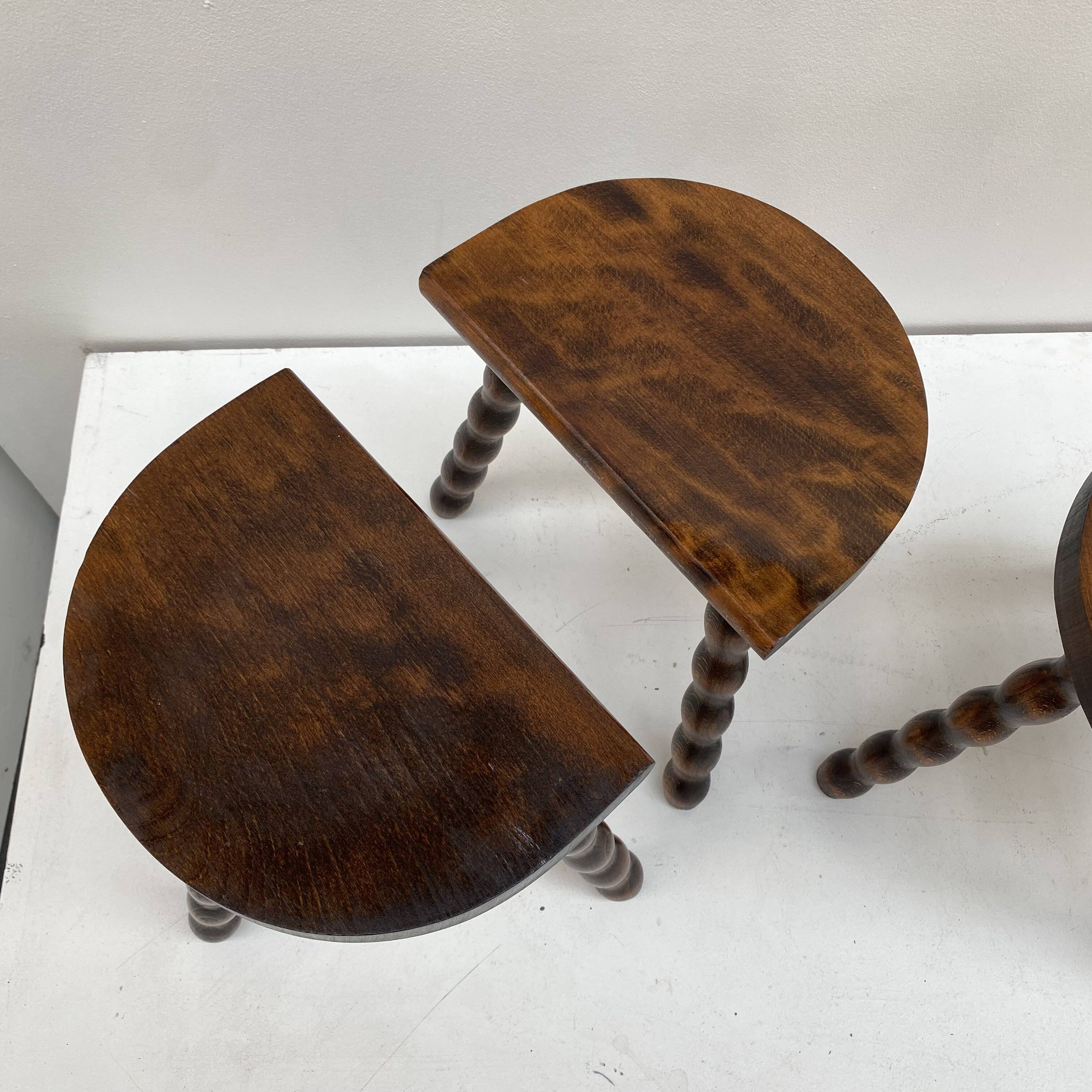 Series of 4 small tripod stools with half-moon seat and beaded turned wood legs