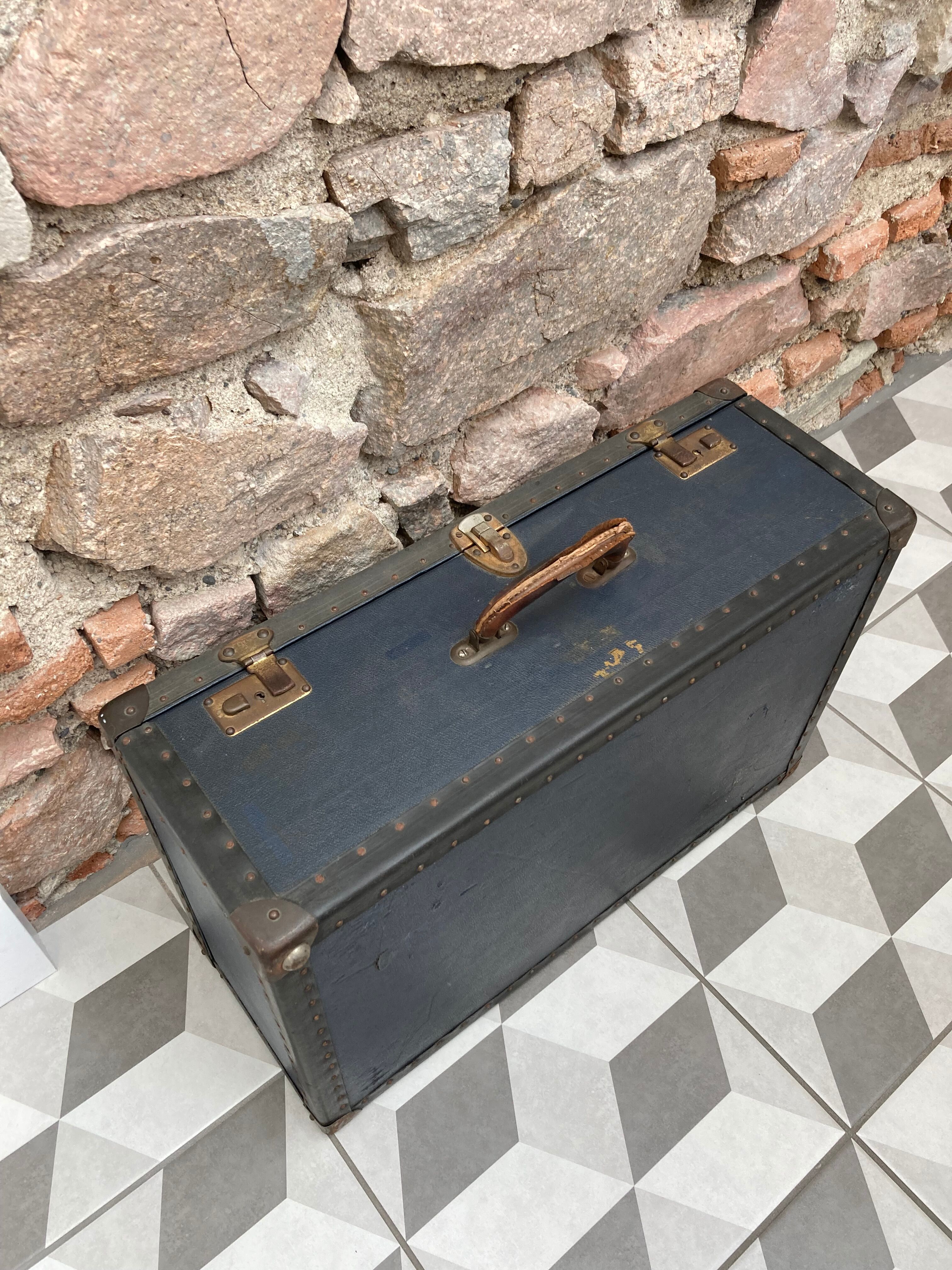 Midnight blue suitcase of representative 30s