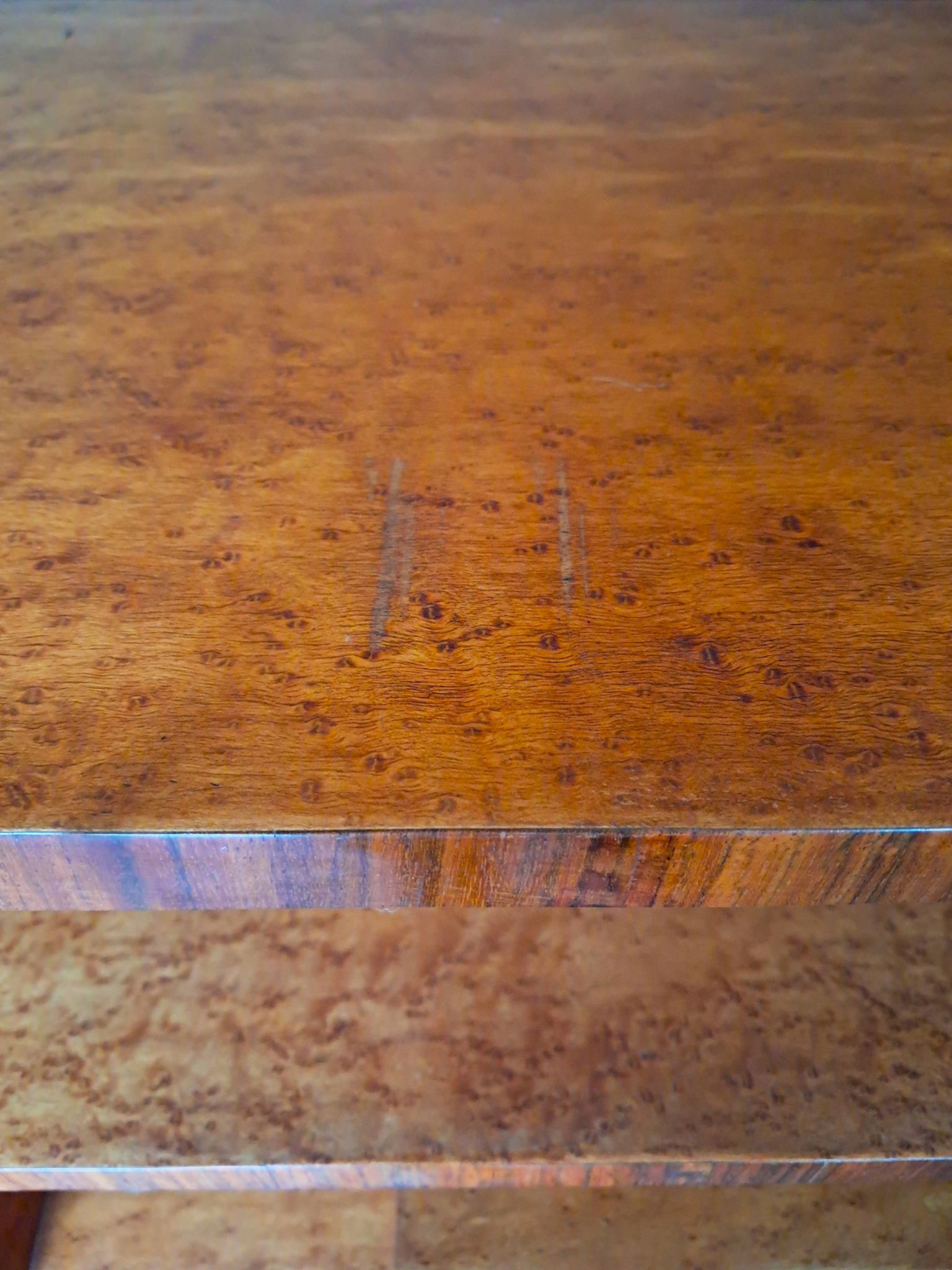 Art Deco cabinet in speckled maple veneer with asymmetrical shelves.