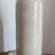 Old bottle in sandstone