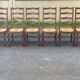 6 solid wood chairs in dark oak with a glossy finish and straw.