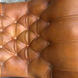 Rocking chair In studded orange leather Chesterfield