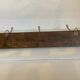 Old coat rack wood metal three hooks
