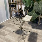 Gold wrought iron ashtray on legs with magazine rack and marbled shelf